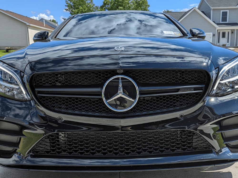 Mercedes-Benz front end after multi-stage machine polish: deep gloss and clear reflections